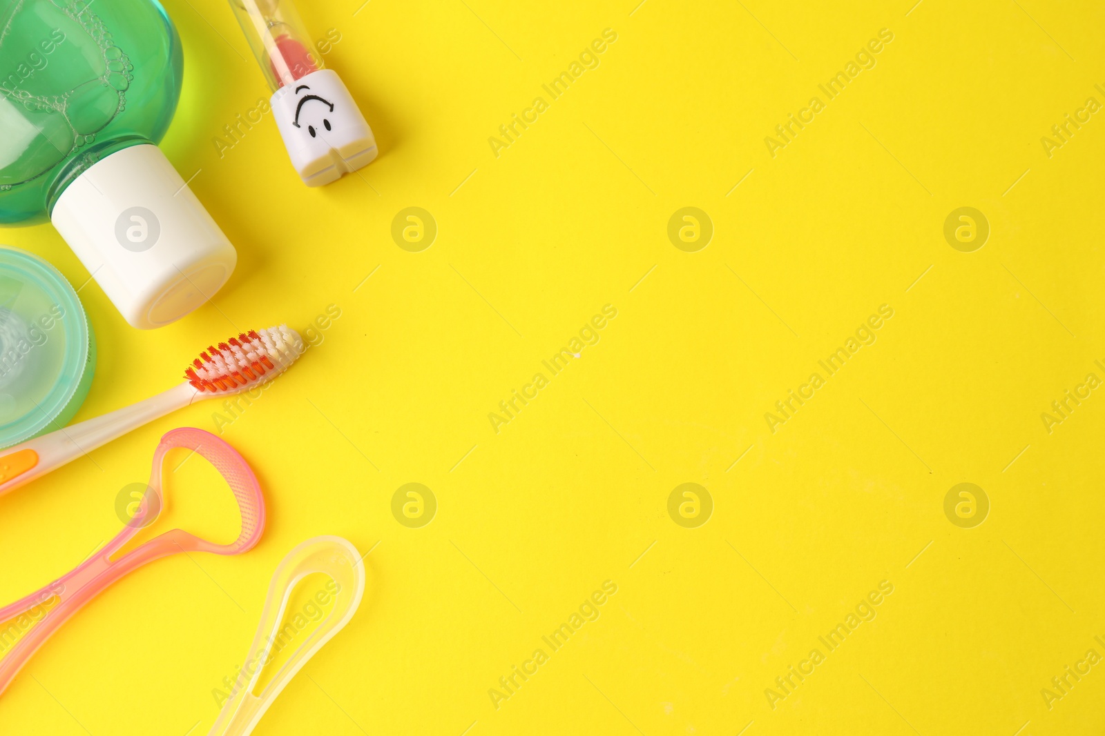 Different oral care products on yellow background, flat lay. Space for text Photo of Different oral care products on yellow background, flat lay. Space for text