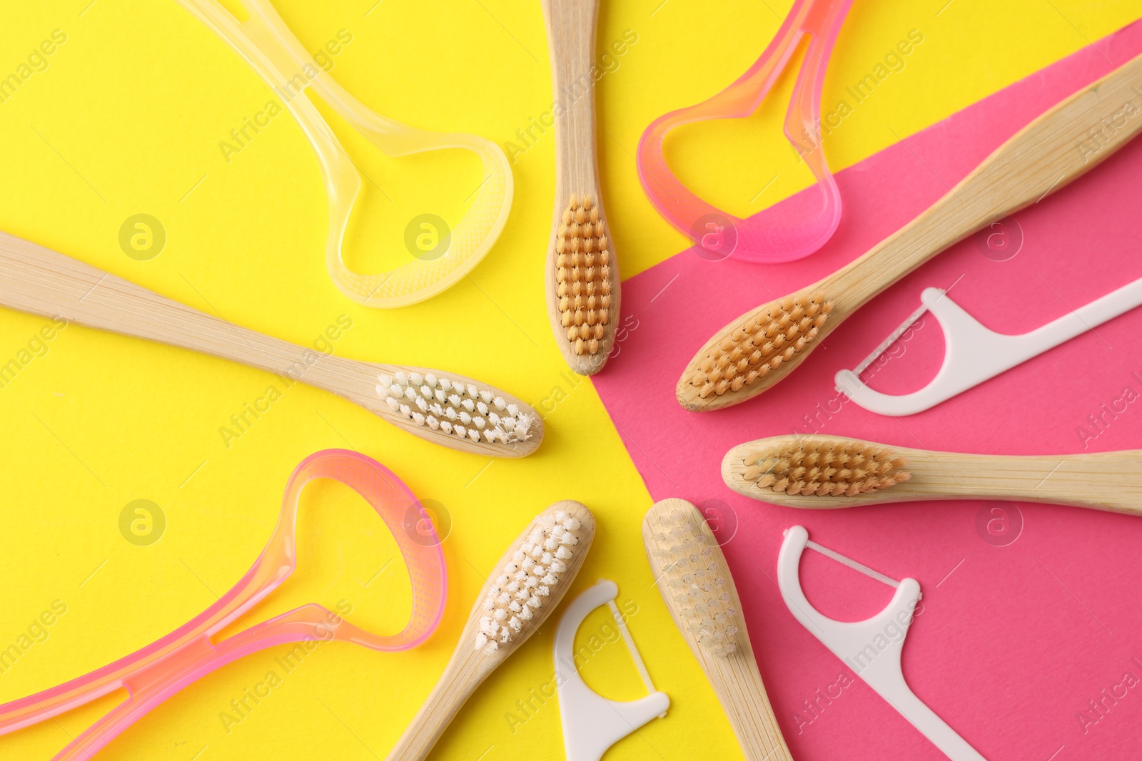 Toothbrushes, tongue cleaners and floss picks on color background, flat lay Photo of Toothbrushes, tongue cleaners and floss picks on color background, flat lay