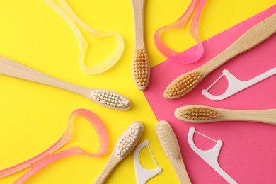 Photo of Toothbrushes, tongue cleaners and floss picks on color background, flat lay