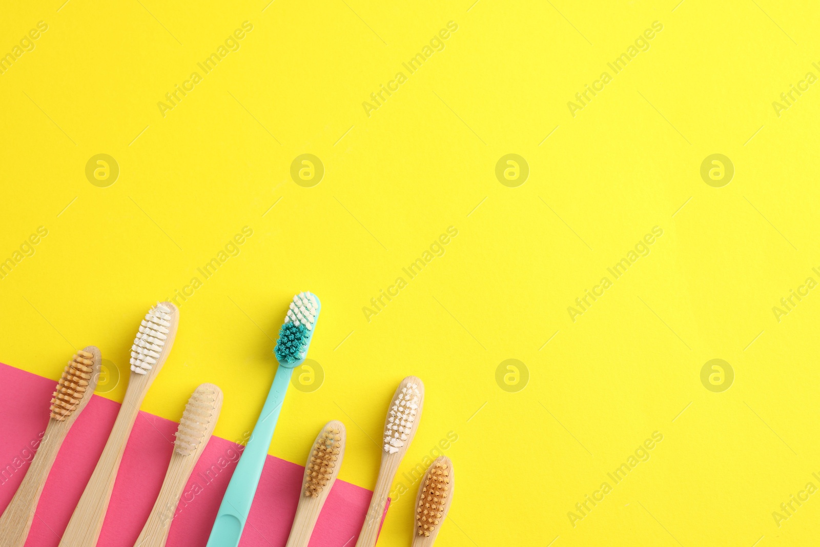 Different toothbrushes on color background, flat lay. Space for text Photo of Different toothbrushes on color background, flat lay. Space for text
