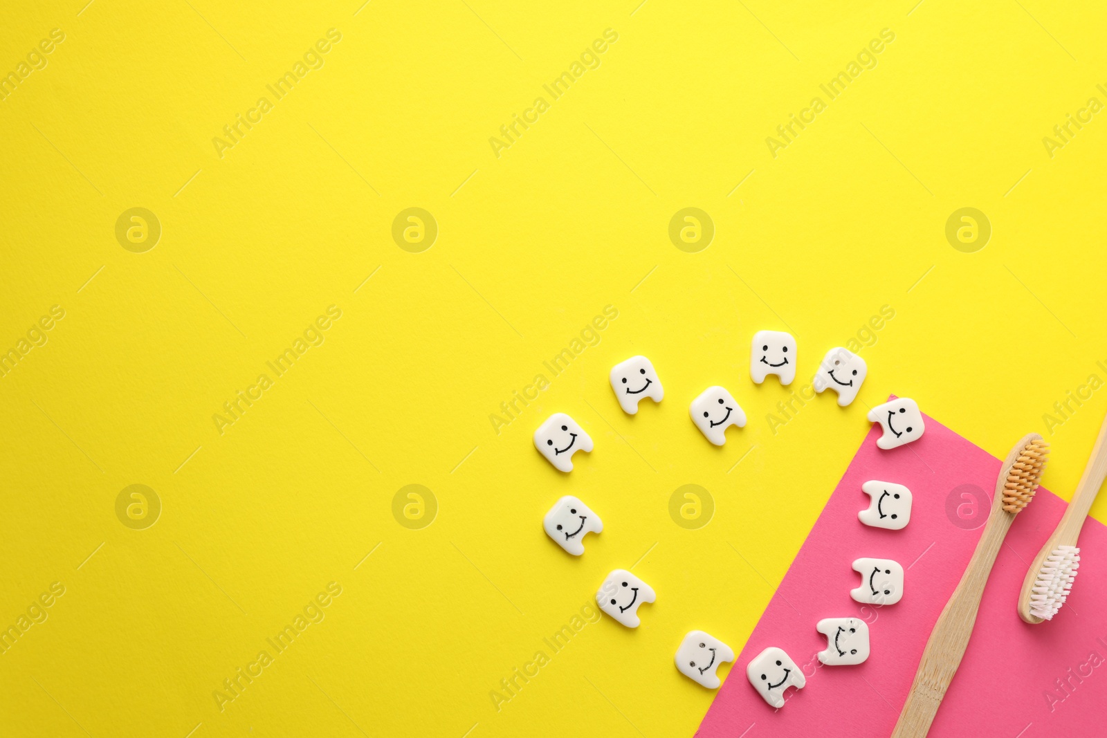 Toothbrushes and teeth figures on color background, flat lay. Space for text Photo of Toothbrushes and teeth figures on color background, flat lay. Space for text