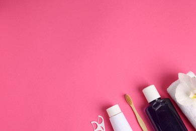 Photo of Different oral care products on pink background, flat lay. Space for text