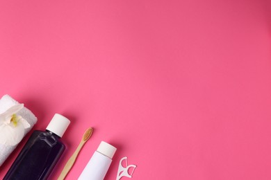 Photo of Different oral care products on pink background, flat lay. Space for text