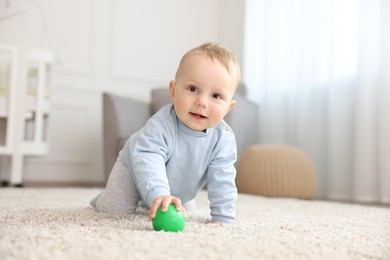 Photo of Cute little baby crawling on floor at home