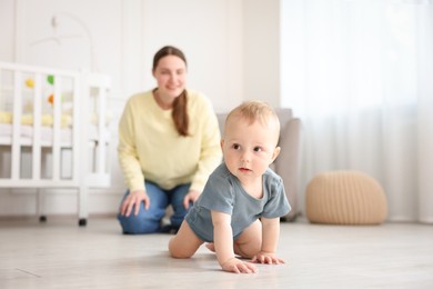 Photo of Mother and her little baby at home, selective focus