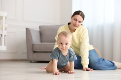 Photo of Mother and her little baby at home, selective focus. Space for text