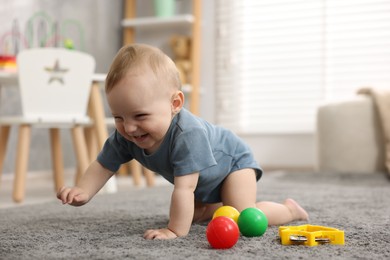 Photo of Cute little baby crawling on floor at home