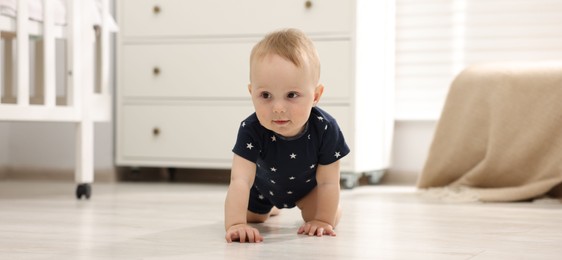 Photo of Cute little baby crawling on floor at home