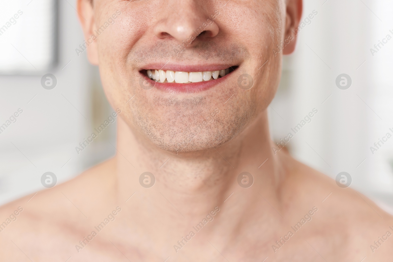 Photo of Smiling man after shaving at home, closeup