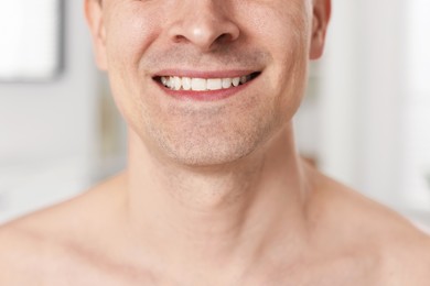 Photo of Smiling man after shaving at home, closeup