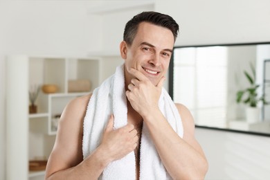 Photo of Portrait of smiling man after shaving at home