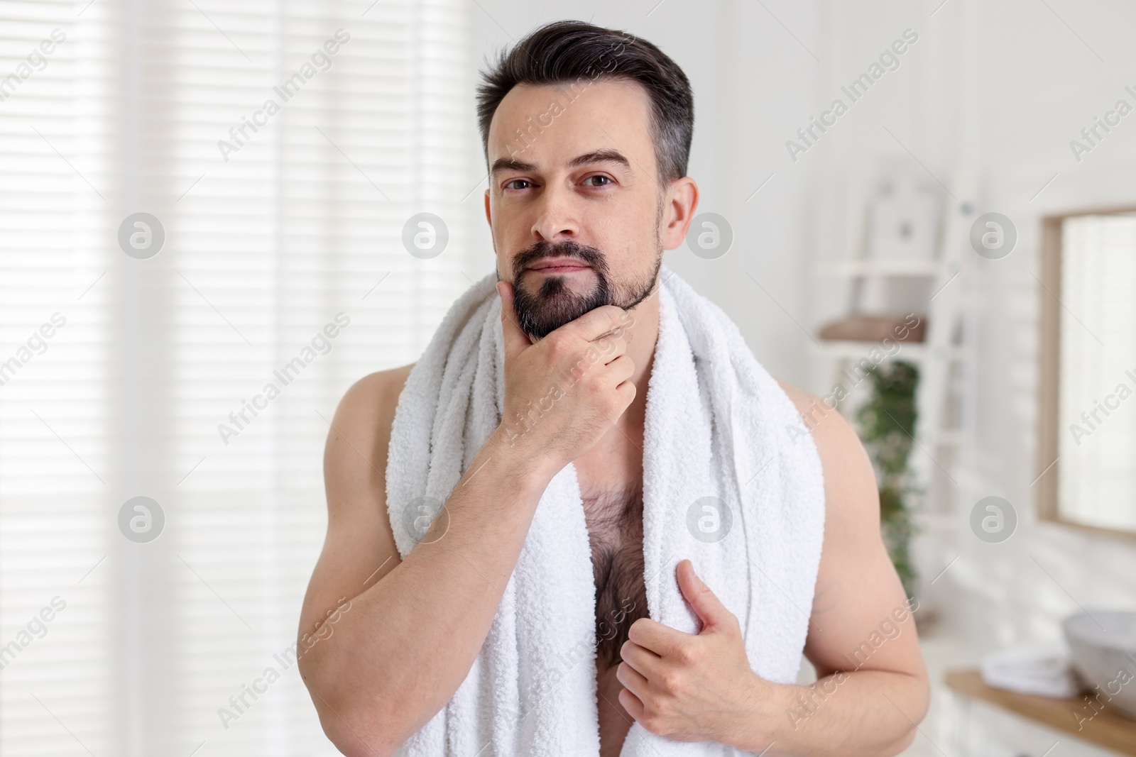Portrait of handsome man before shaving in bathroom Photo of Portrait of handsome man before shaving in bathroom