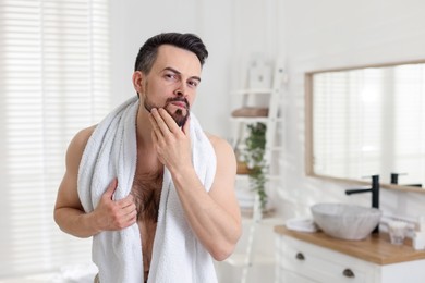 Photo of Portrait of handsome man before shaving in bathroom