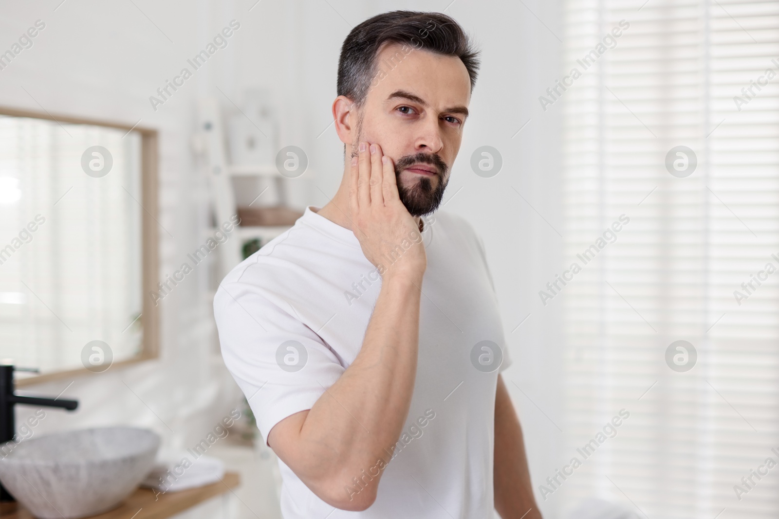 Portrait of handsome man before shaving in bathroom Photo of Portrait of handsome man before shaving in bathroom