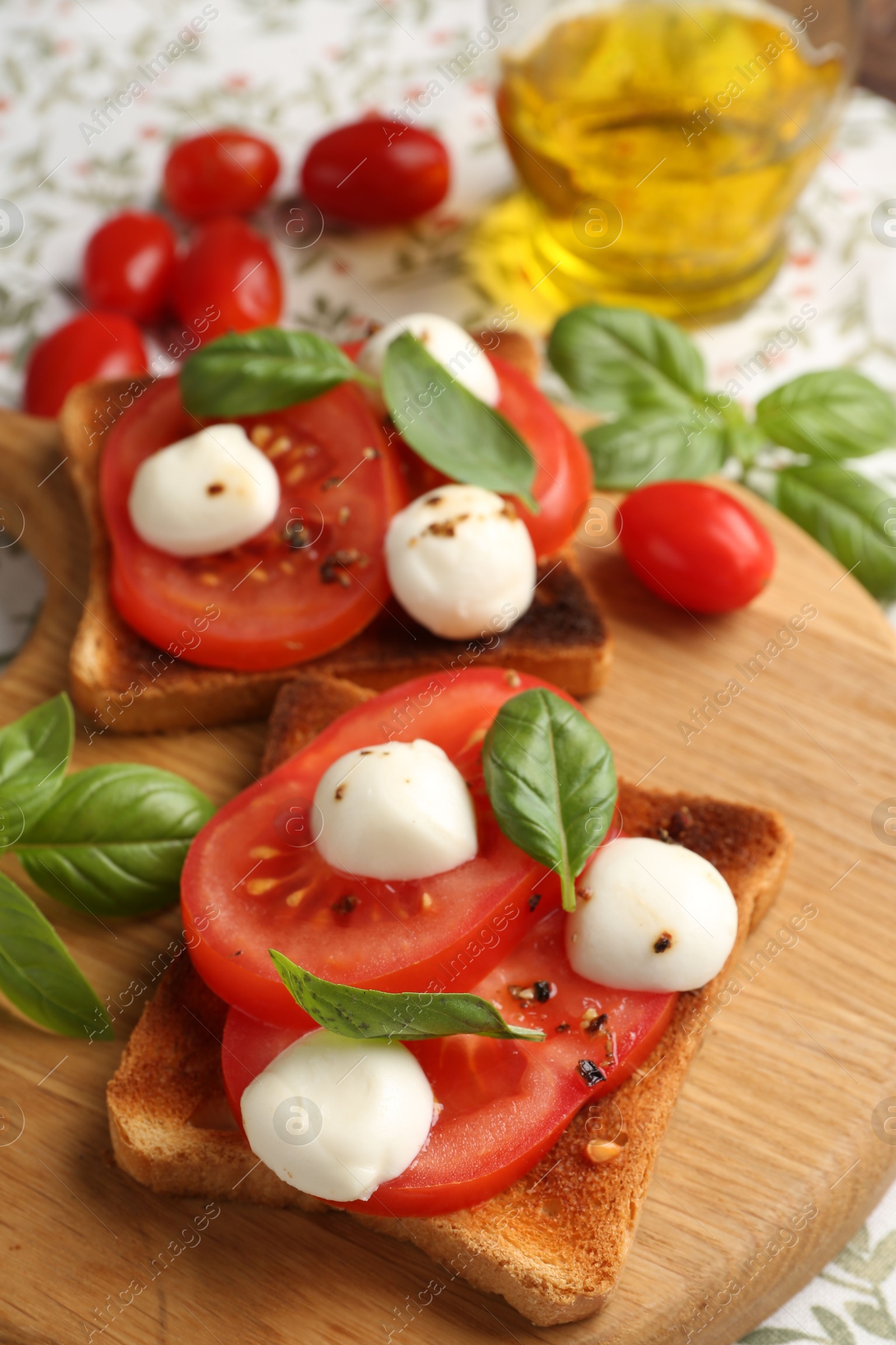 Tasty sandwiches with mozzarella cheese, tomatoes and basil on tablecloth, closeup Photo of Tasty sandwiches with mozzarella cheese, tomatoes and basil on tablecloth, closeup