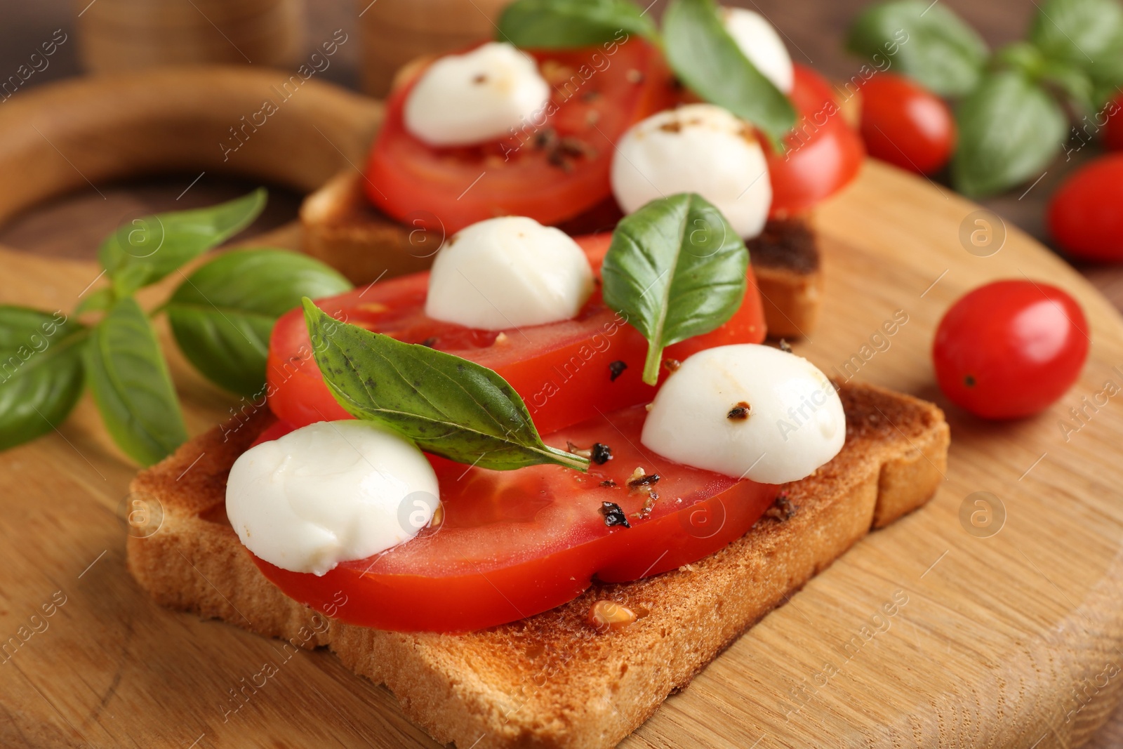 Tasty sandwiches with mozzarella cheese, tomatoes and basil on table, closeup Photo of Tasty sandwiches with mozzarella cheese, tomatoes and basil on table, closeup