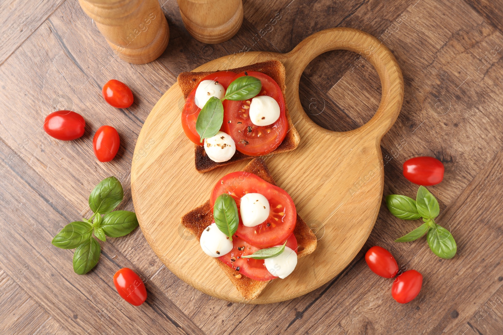 Tasty sandwiches with mozzarella cheese, tomatoes and basil on wooden table, flat lay Photo of Tasty sandwiches with mozzarella cheese, tomatoes and basil on wooden table, flat lay