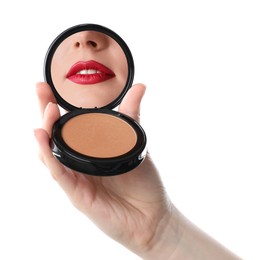 Image of Beautiful woman with red lips looking in compact powder mirror on white background, closeup