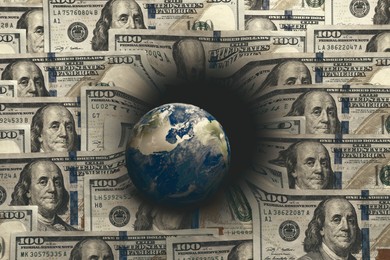 Image of Money exchange concept. Earth planet surrounded by dollar bills