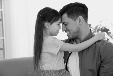 Image of Dad with his daughter at home. Black-and-white toning