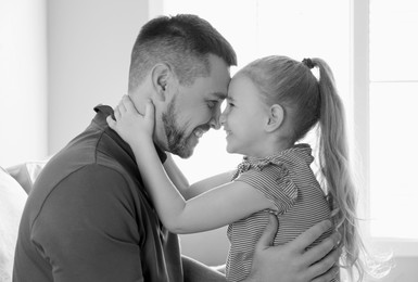 Image of Dad with his daughter at home. Black-and-white toning