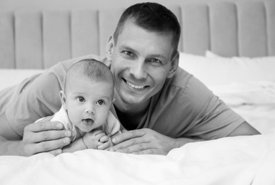 Image of Dad with his baby daughter at home. Black-and-white toning