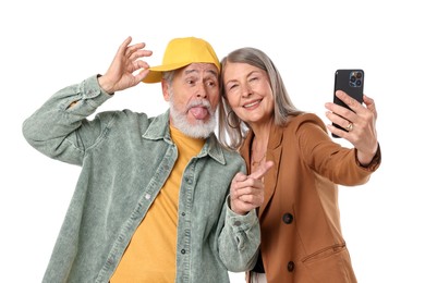 Photo of Senior couple in stylish outfits taking selfie on white background