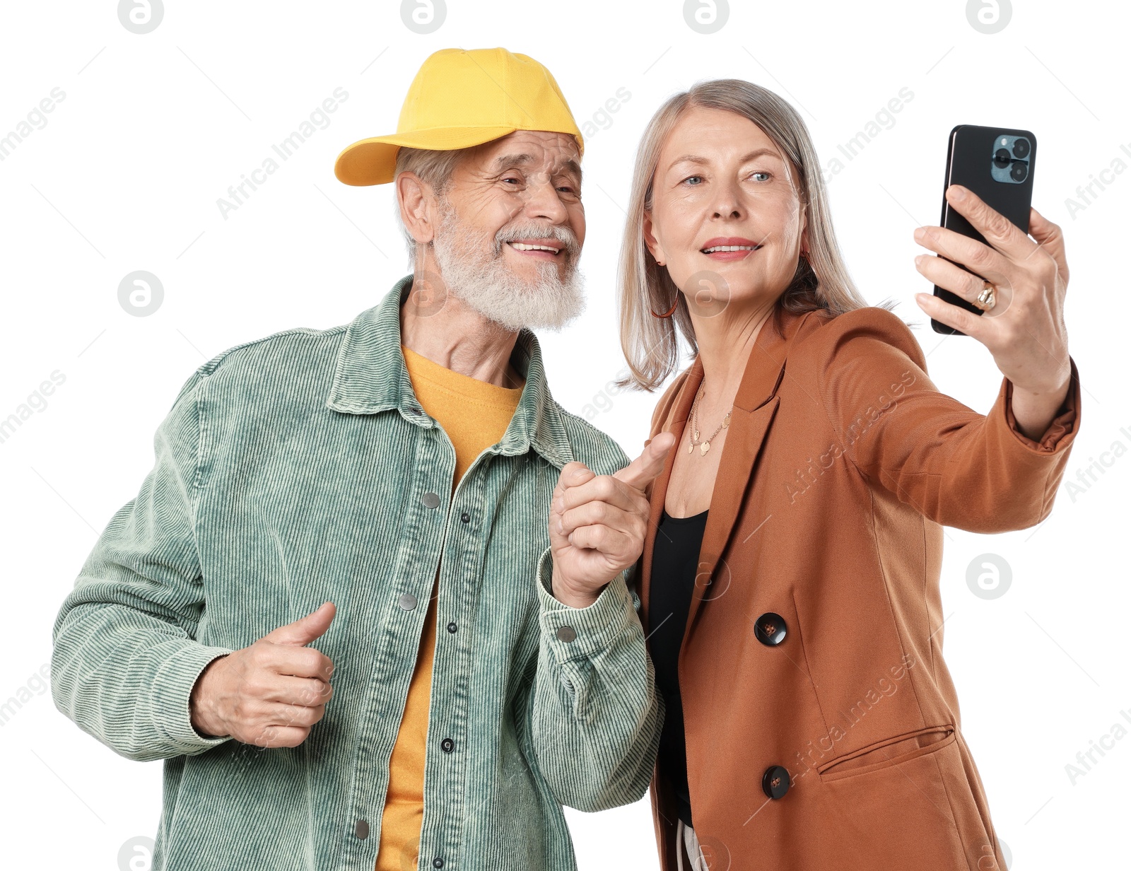 Senior couple in stylish outfits taking selfie on white background Photo of Senior couple in stylish outfits taking selfie on white background