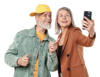 Photo of Senior couple in stylish outfits taking selfie on white background