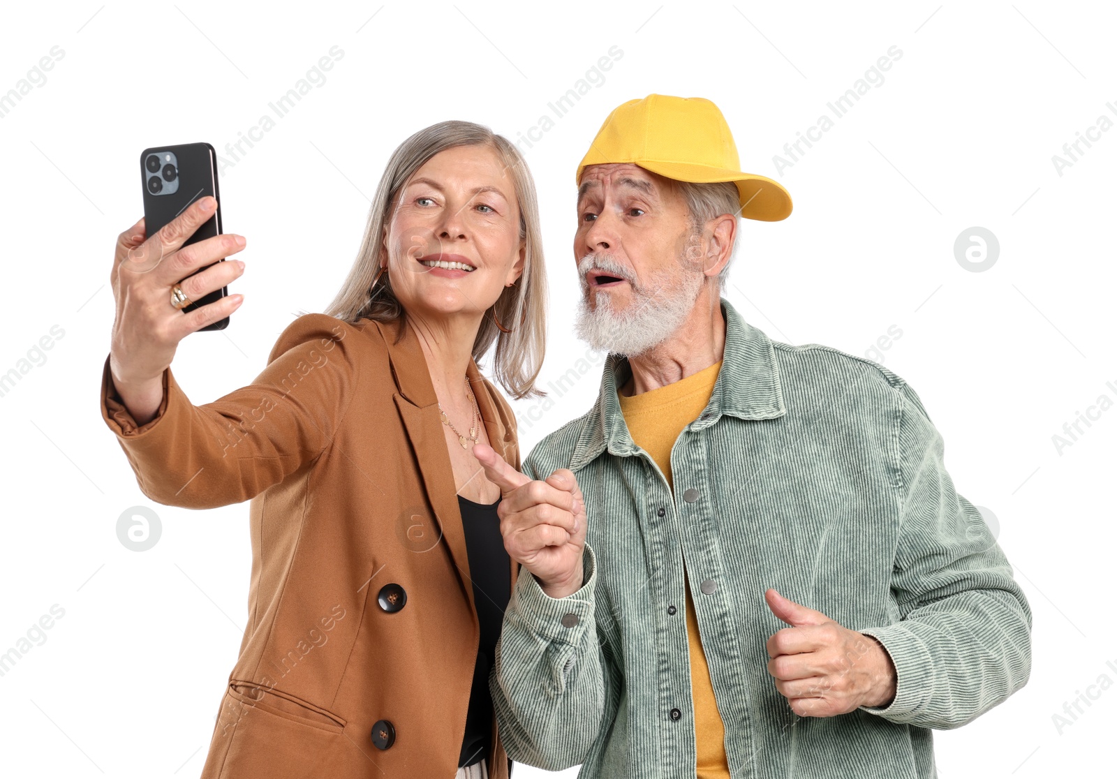 Senior couple in stylish outfits taking selfie on white background Photo of Senior couple in stylish outfits taking selfie on white background