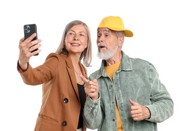 Photo of Senior couple in stylish outfits taking selfie on white background