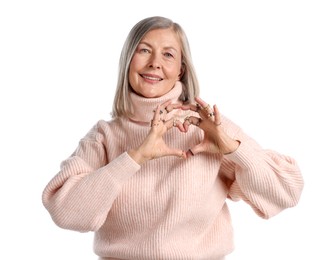 Photo of Senior woman wearing different rings and making heart gesture on white background