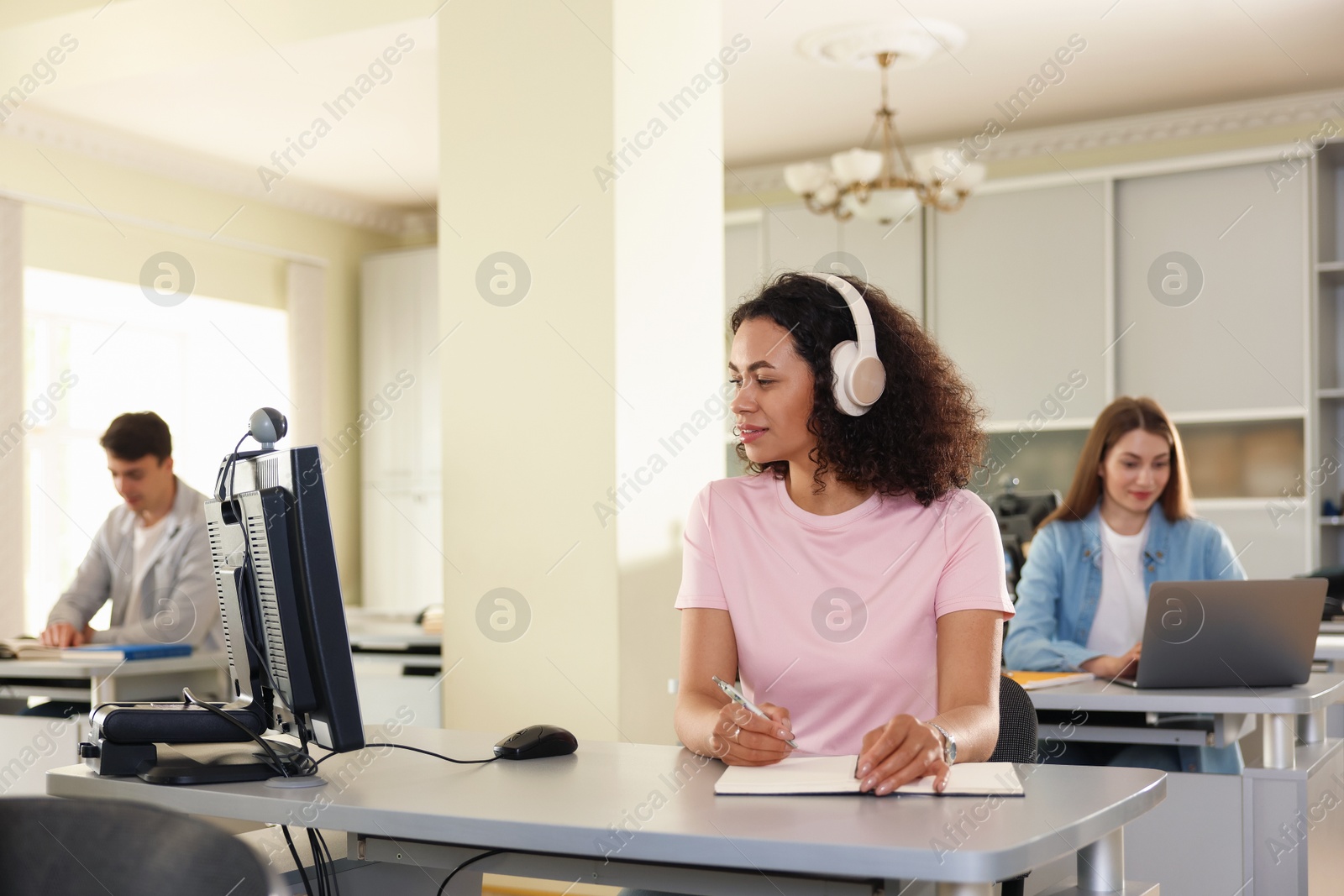 People working at desks in library, selective focus Photo of People working at desks in library, selective focus