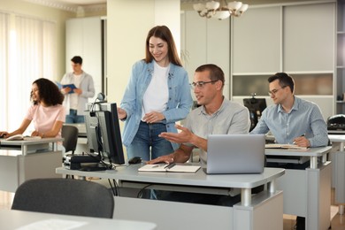 Photo of People studying together in library, selective focus