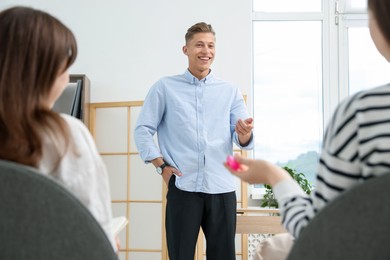 Photo of Group of people having meeting during life coaching class indoors