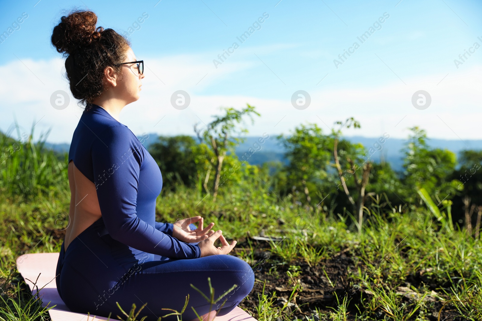 Woman meditating on yoga mat outdoors. Space for text Photo of Woman meditating on yoga mat outdoors. Space for text