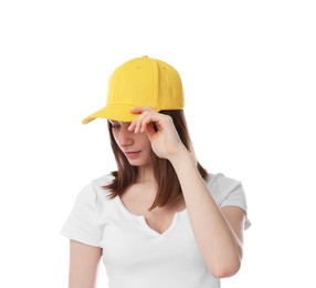 Photo of Young woman wearing stylish yellow baseball hat on white background