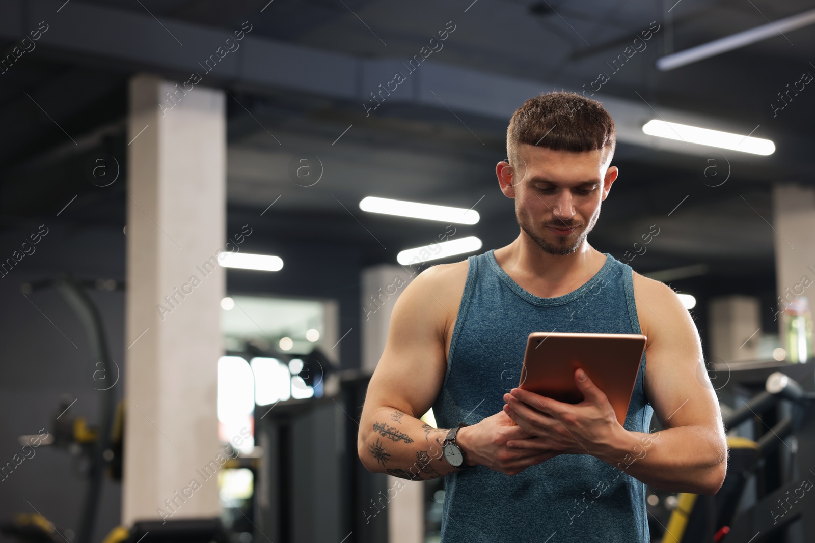Personal trainer with tablet in sport center. Space for text Photo of Personal trainer with tablet in sport center. Space for text