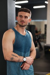 Photo of Portrait of professional personal trainer in gym