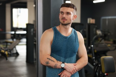 Photo of Portrait of professional personal trainer in gym