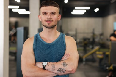 Photo of Portrait of professional personal trainer in gym