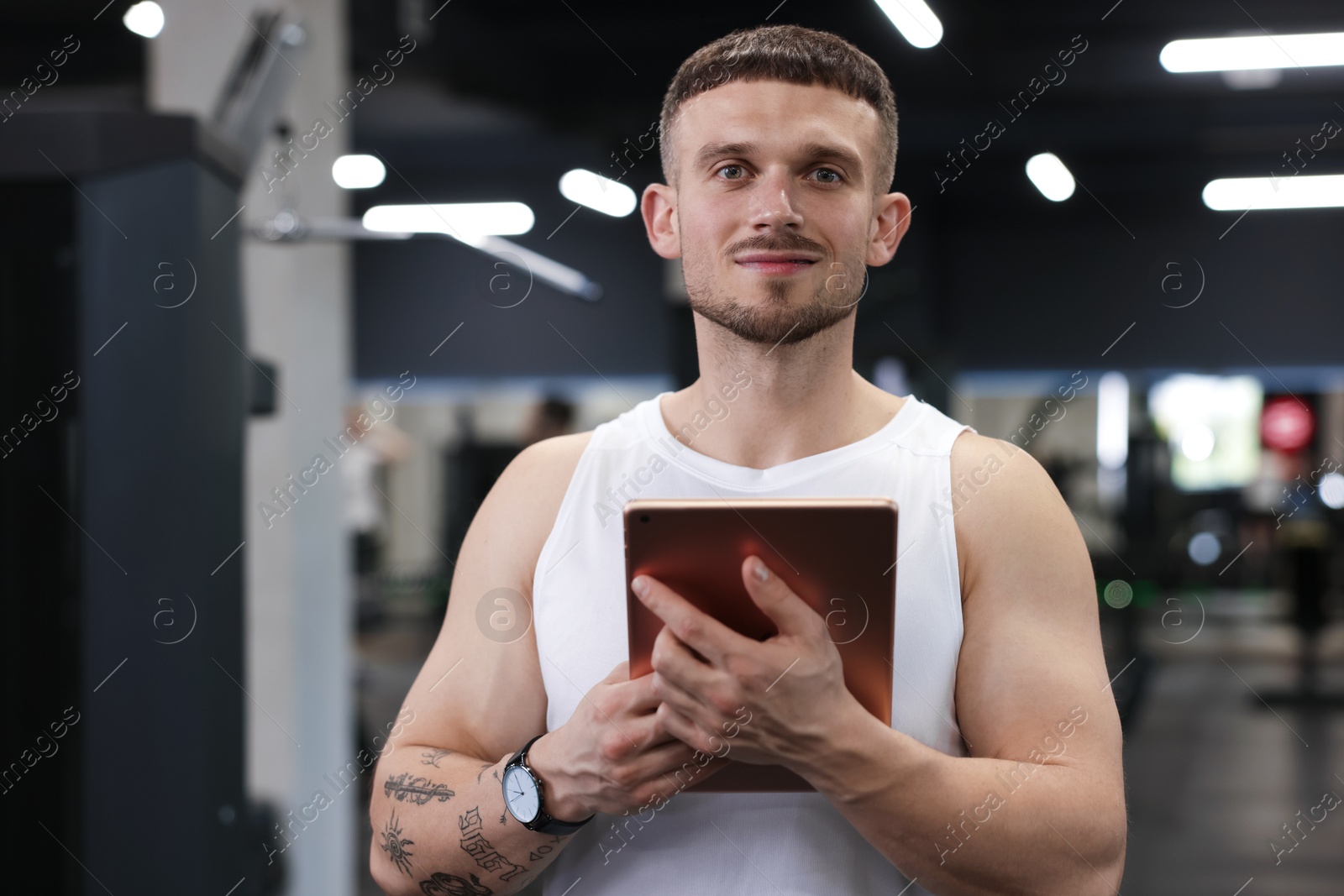 Personal trainer with tablet in sport center Photo of Personal trainer with tablet in sport center