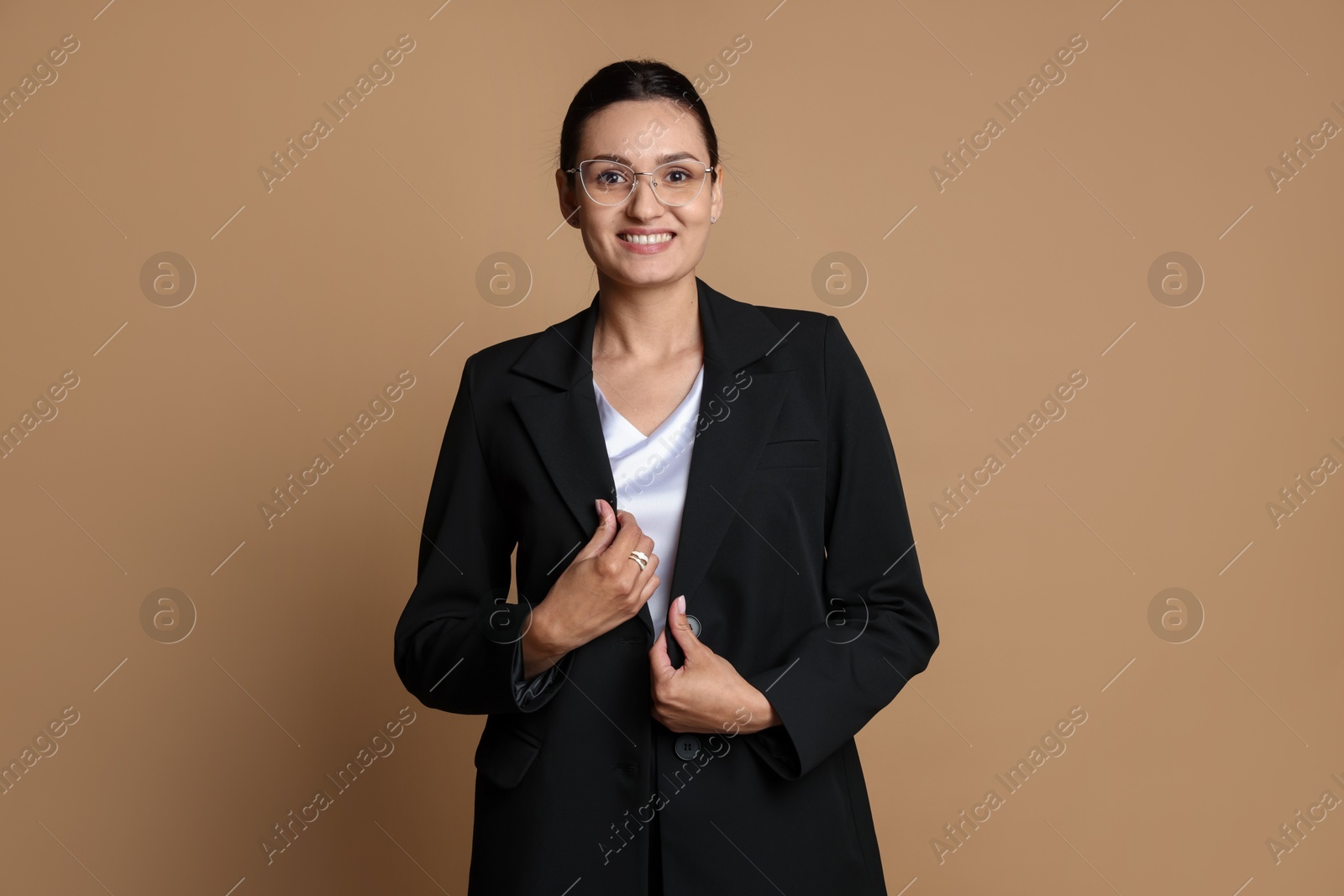Photo of Confident business woman in suit on beige background