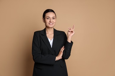 Photo of Confident business woman in suit on beige background