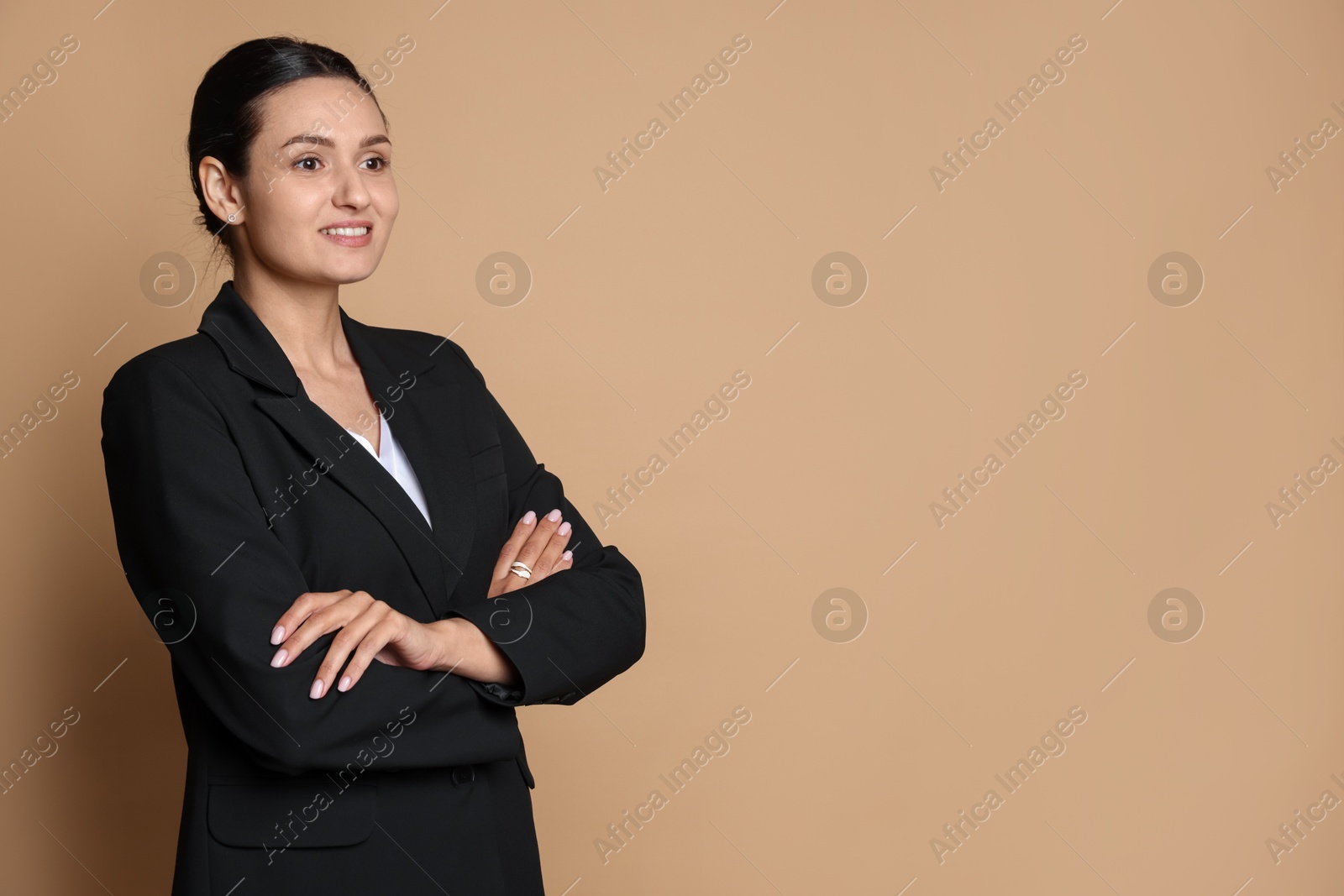 Confident business woman in suit on beige background. Space for text Photo of Confident business woman in suit on beige background. Space for text