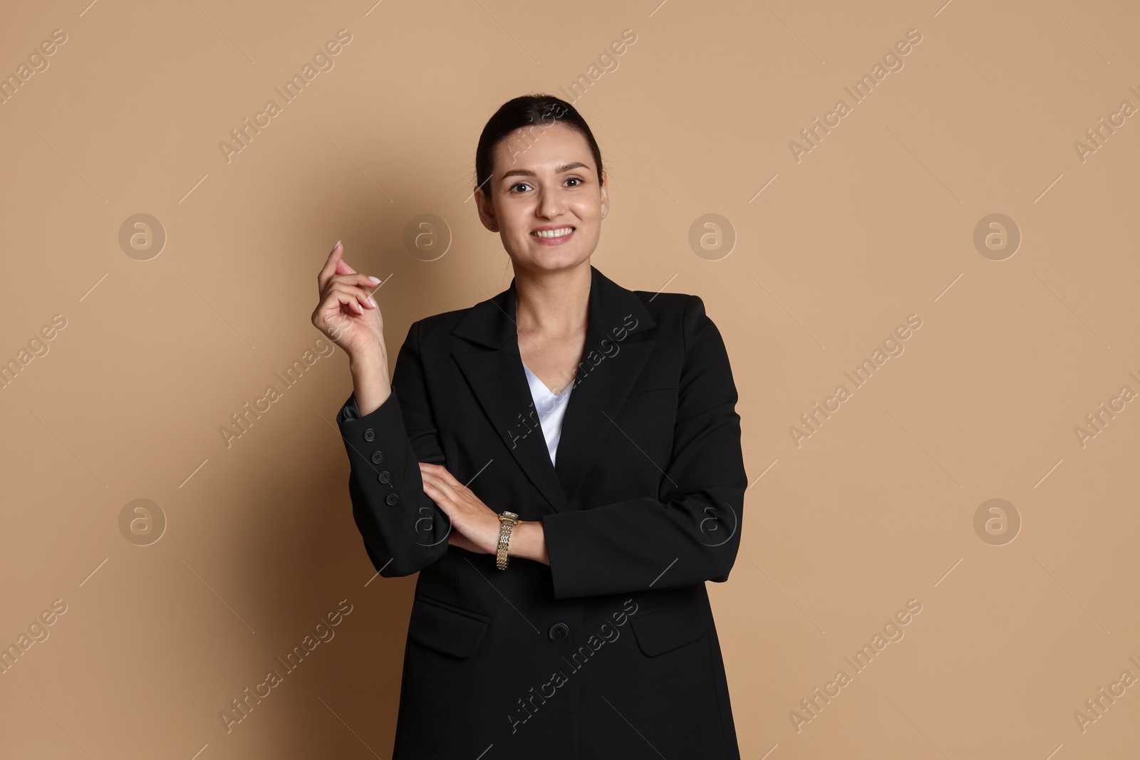 Confident business woman in suit on beige background Photo of Confident business woman in suit on beige background