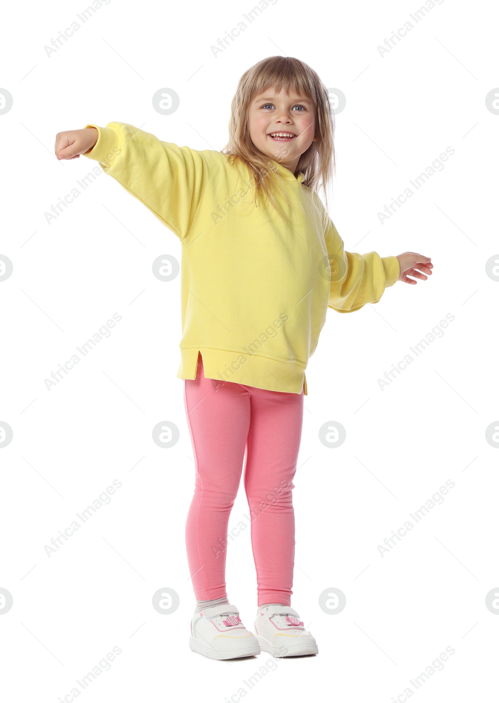 Happy little girl dancing on white background Photo of Happy little girl dancing on white background