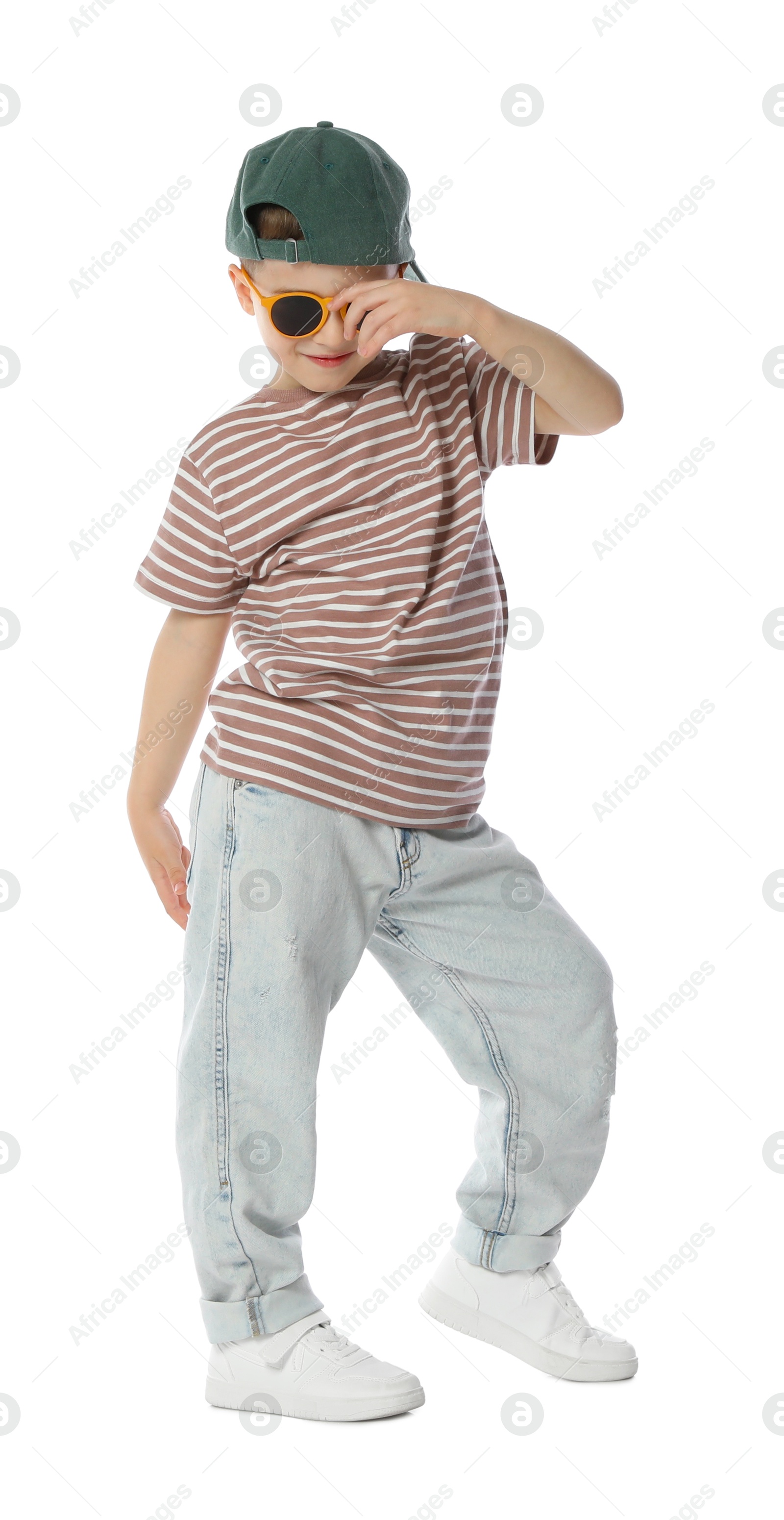 Cute little boy in sunglasses and baseball hat dancing on white background Photo of Cute little boy in sunglasses and baseball hat dancing on white background