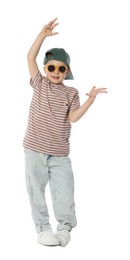 Photo of Happy little boy in sunglasses and baseball hat dancing on white background