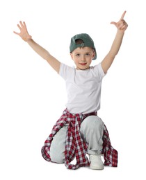 Photo of Happy little boy in baseball hat dancing on white background